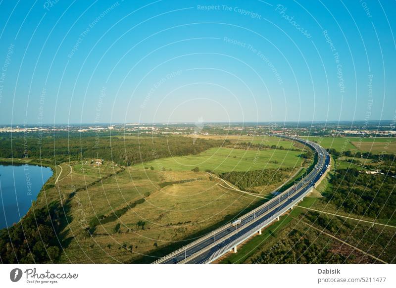 Cars driving on highway road near green fields, top view traffic car transportation bridge landscape overhead countryside above aerial asphalt auto automobile