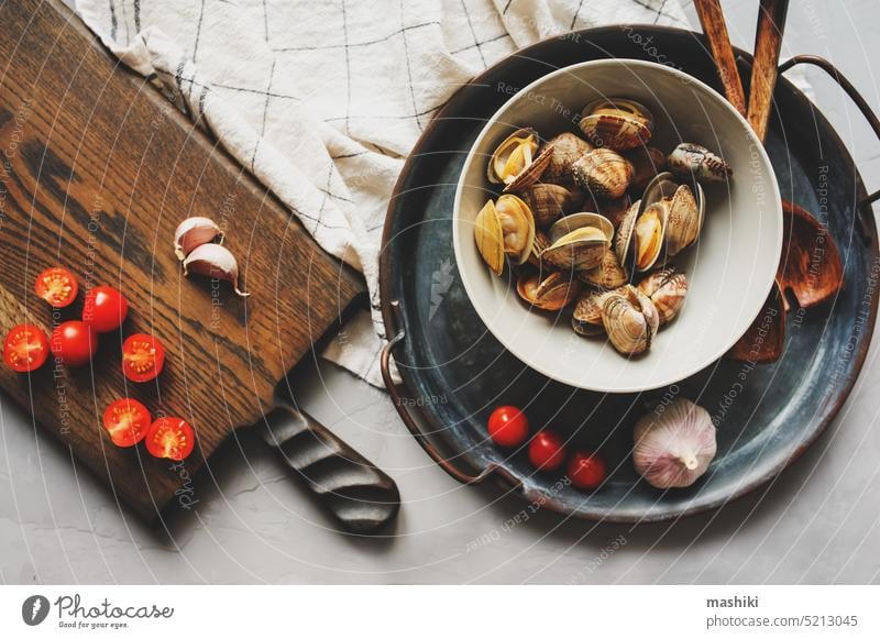 Raw Shells Clams vongole on plate. Ingredients for cooking seafood pasta. Meditterian cuisine. clam shell raw fresh shellfish meal garlic healthy mussel edible