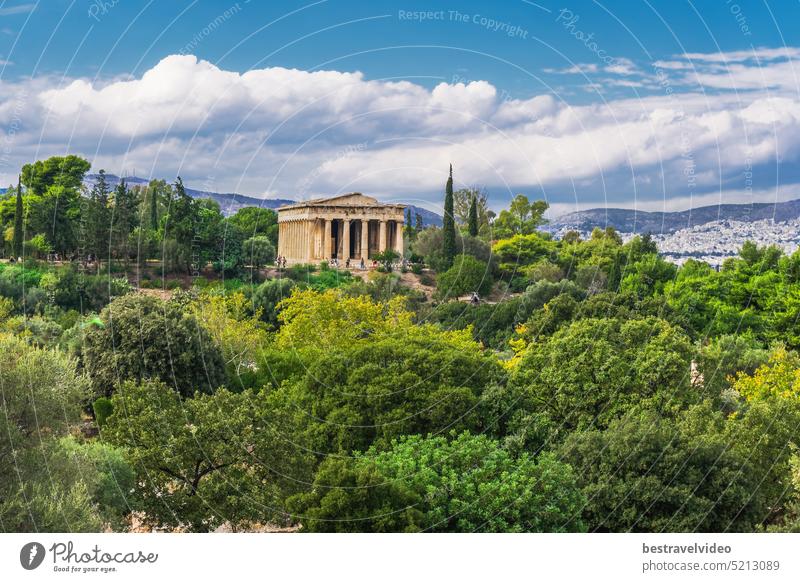 Athens Greece Temple Of Hephaestus day view surrounded by greenery on a bright sunshine over puffy clouds. Athens Temple Of Hephaestus column greece temple