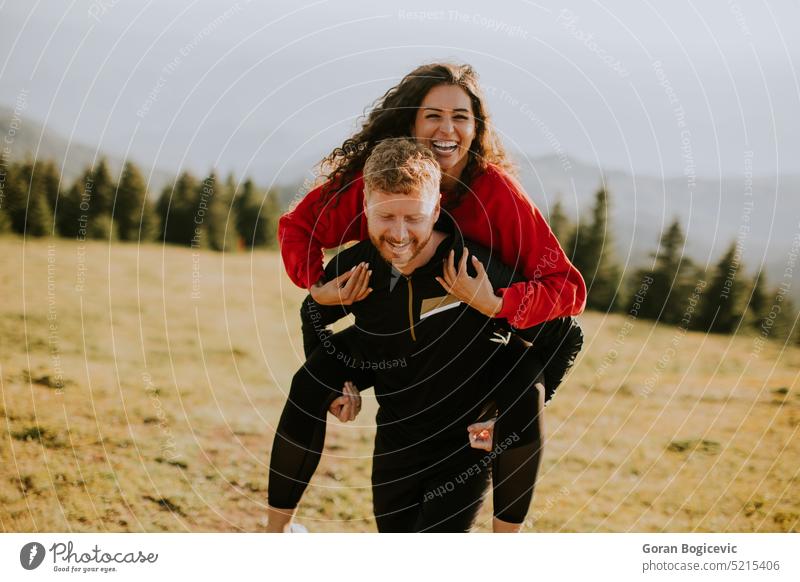 Rear view of two young active couple walking down the trail path on forest.  - a Royalty Free Stock Photo from Photocase