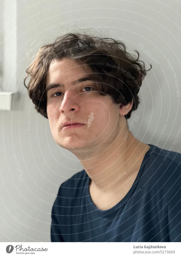 Portrait of a young man with a white wall on the background. portrait Young man Looking into the camera Face Adults Portrait photograph Human being Masculine