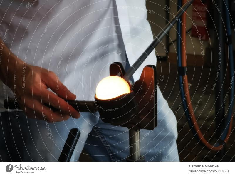 Glass blowing - a hot ball is preformed Arts and crafts Light Dark Black Shadow Bright Contrast Human being glass blowing Craft (trade) Close-up Blue Colour