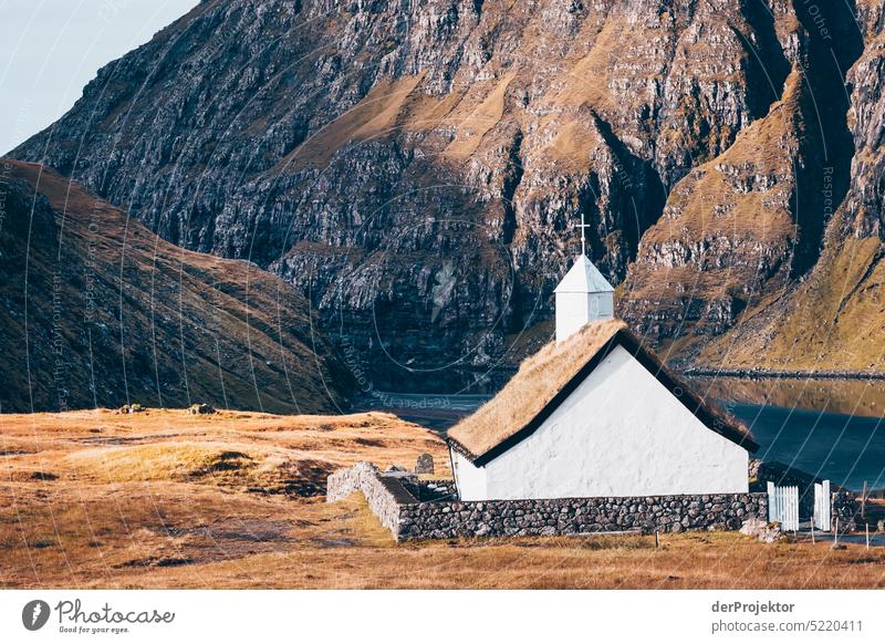 View of a church in sunlight II Street rocky Bad weather Environment Hill Rock highlands Rural harmony Weather Picturesque Faroe Islands Sunlight idyllically