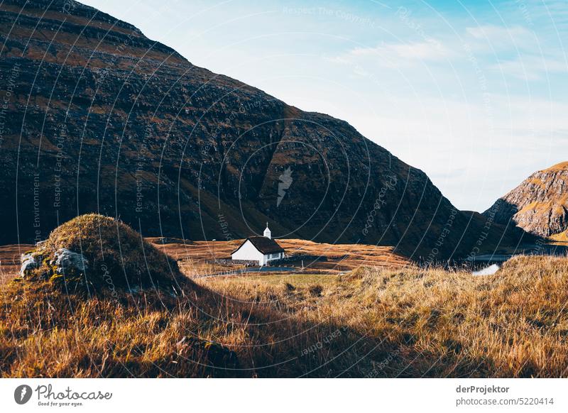 View of a church in sunlight Street rocky Bad weather Environment Hill Rock highlands Rural harmony Weather Picturesque Faroe Islands Sunlight idyllically