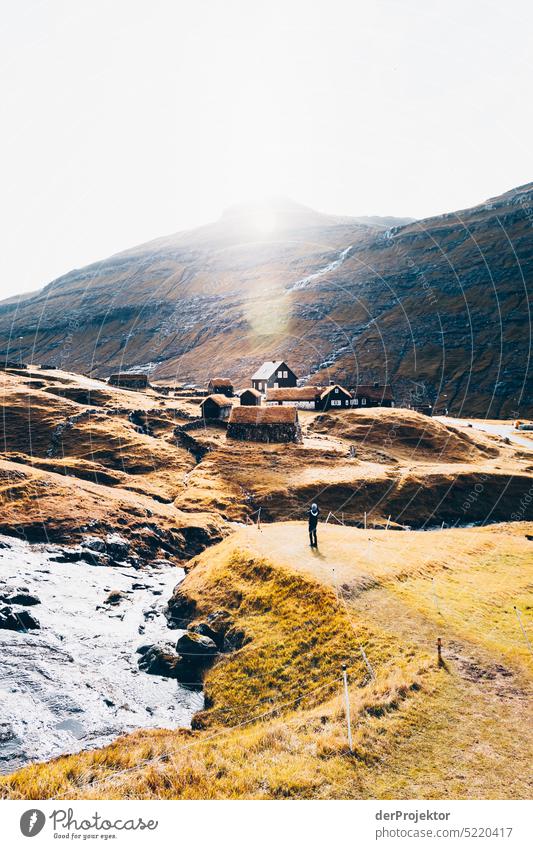 View of houses in sunlight Street rocky Bad weather Environment Hill Rock highlands Rural harmony Weather Picturesque Faroe Islands Sunlight idyllically