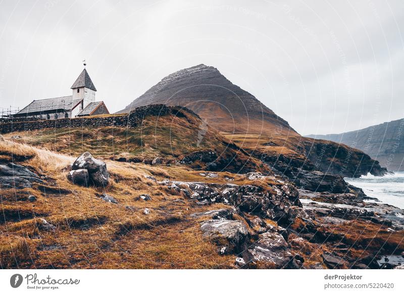 View of a church in bad weather Street rocky Bad weather Environment Hill Rock highlands Rural harmony Weather Picturesque Faroe Islands Sunlight idyllically