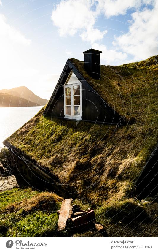 View of offshore island with green roof of house in sunlight II Street rocky Bad weather Environment Hill Rock highlands Rural harmony Weather Picturesque