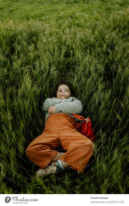 Cute girl lying on the grass Girl Child 3 - 8 years Infancy Colour photo Human being Exterior shot Feminine Day Playing Authentic Grass Spring Spring flower