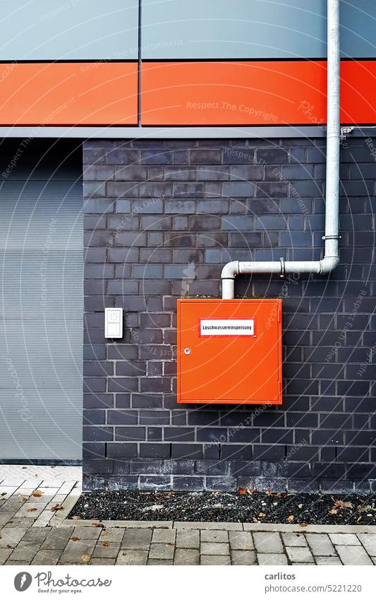 Wall with 'box | fire water supply Wall (building) Box Orange signal colour clinker cladding panels Silver Water for firefighting fire-fighting water feed Fire