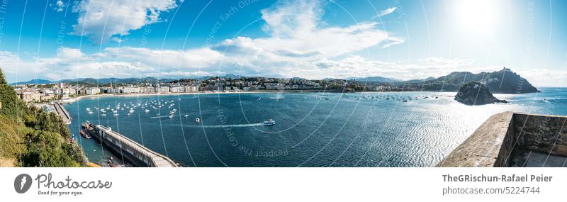 Panorama of bay with hill in background Sun houses Hill Ocean Water Summer Blue Nature Bay donostia san sebastian Spain San Sebastián Basque Country Landscape