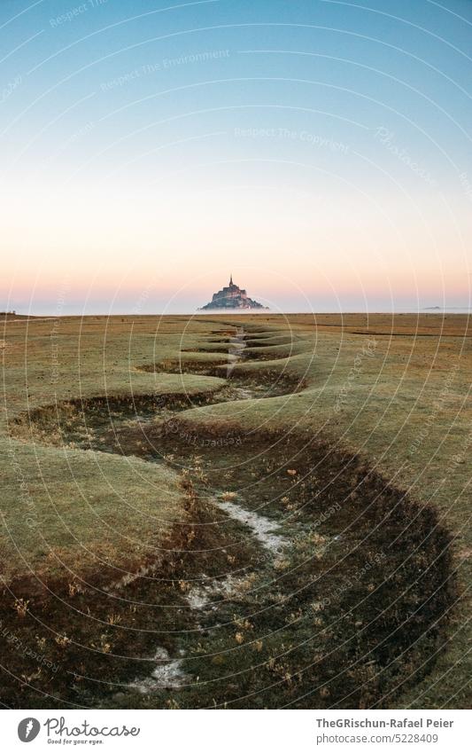 Dry riverbed in front of Mont Saint Michel in morning mist Meadow Blue sky Grass Landscape mont saint michel Mont St. Michel France Landmark Tourism