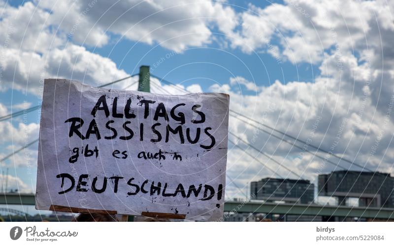 Everyday racism also existed in Germany. Protest sign at a demonstration against racism . Everyday Racism Skin color Origins equality Migration denounce sb.