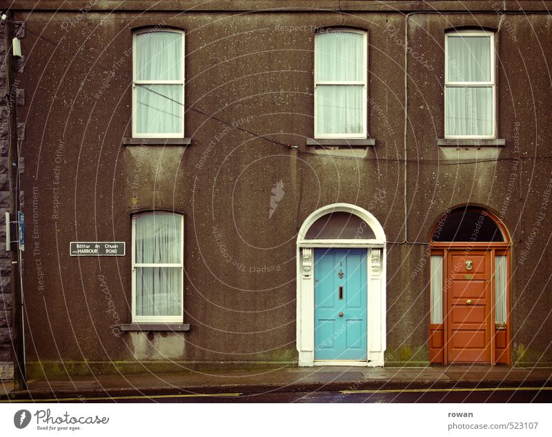 individuality House (Residential Structure) Detached house Wall (barrier) Wall (building) Facade Window Door Old Gloomy Town Blue Red Entrance Front door
