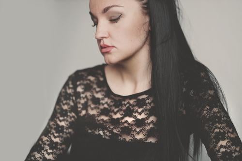 Profile of a black-haired woman Woman Black-haired Ponytail hairstyle sad Grief Hair and hairstyles portrait Feminine Long-haired Young woman pretty Face Adults