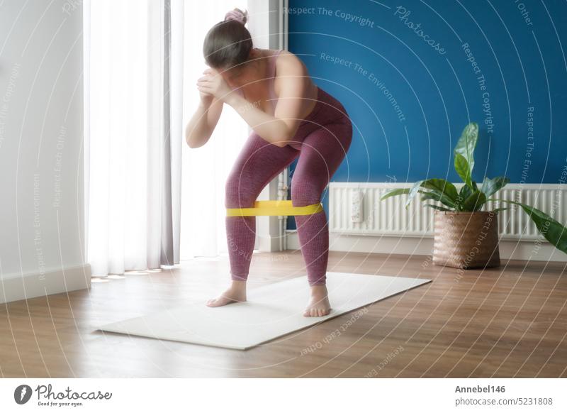 Dumbbells and Exercise Band on a Yoga Mat for a Home Workout Stock