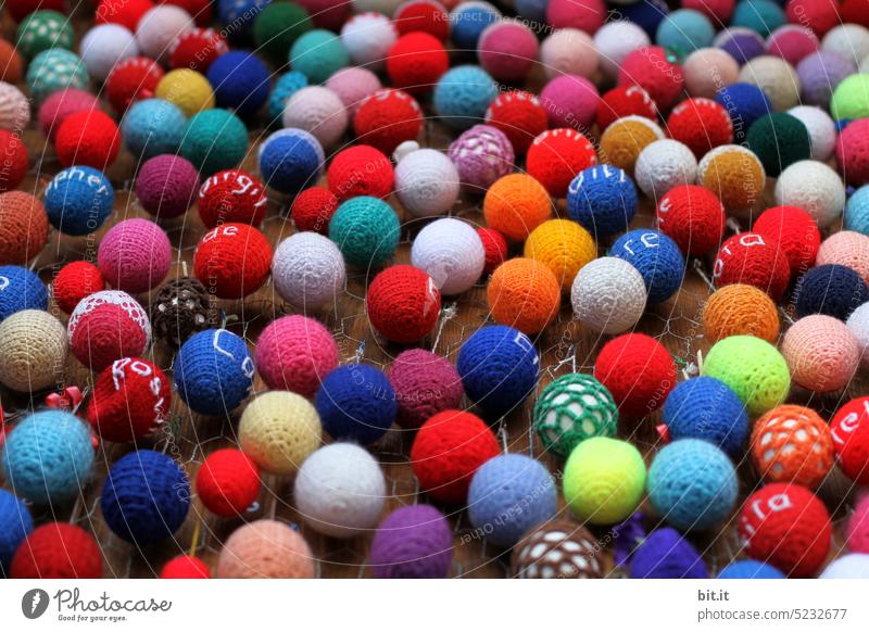 This fits like a glove l collection l many, colorful, hand-knitted Easter eggs hang together on a wooden wall. Lot of homemade easter eggs. Craft idea, decoration, colors & patterns. Exhibition of eggs design, decorate a wall for Easter.