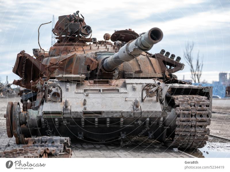 damaged military tank on a city street in Ukraine Donetsk Kherson Lugansk Mariupol Russia Zaporozhye abandon abandoned armor attack bakhmut blown up bombardment