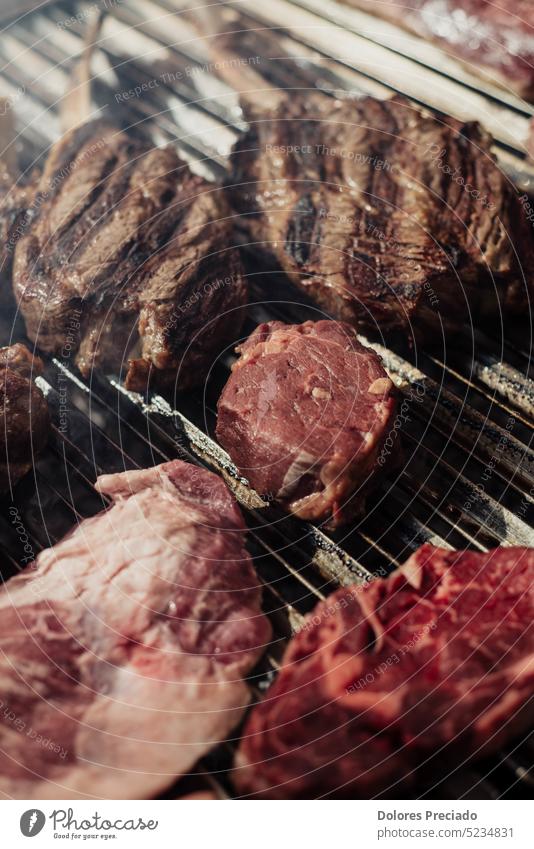 Some excellent pieces of Argentinian beef on a charcoal grill appetizing background barbecue barbeque barbequing bbq bone-in braai closeup cooked cooking