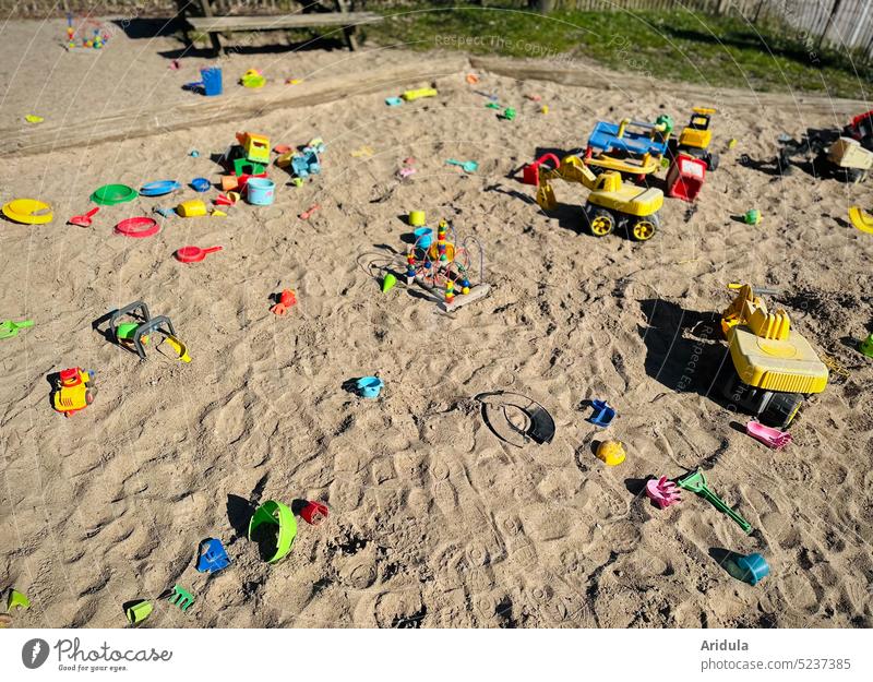 Orphaned sandbox with colorful toys Toys Infancy variegated Sand plastic Plastic Shovel Excavator Bucket Sieve children Kindergarten Playground Bench moulds