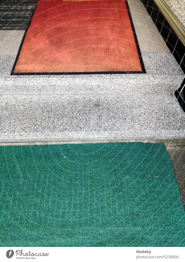 Staircase to an old store and business with doormat and runner in red and green in the city center of Lage near Detmold in East Westphalia Lippe Location