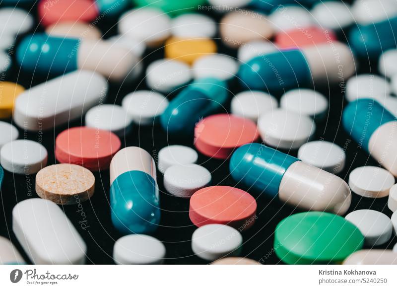 Pharmacy theme. Multicolored Isolated Pills and Capsules on Black Surface. Vitamins, drugs concept. COVID-19, Coronavirus, epidemic pill capsule medicine health