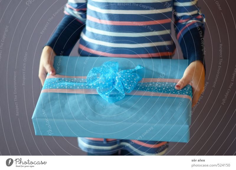 a second Feasts & Celebrations Birthday First day at school Feminine Girl Infancy Upper body Hand 1 Human being Gift Gift wrapping To hold on Blue Happy