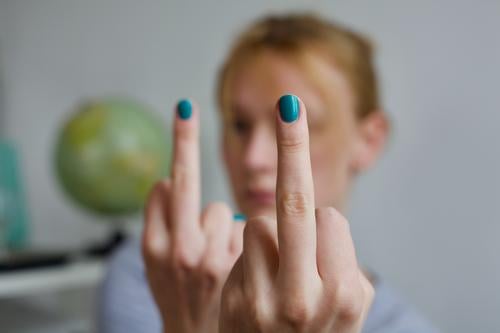 Fuck you. And so much so. | Young woman holds two stretched middle fingers with green painted fingernails into the camera. fuck you Middle finger Anger