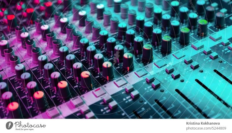 Close up of sound mixing console. Details of sound engineer room. Neon  light - a Royalty Free Stock Photo from Photocase