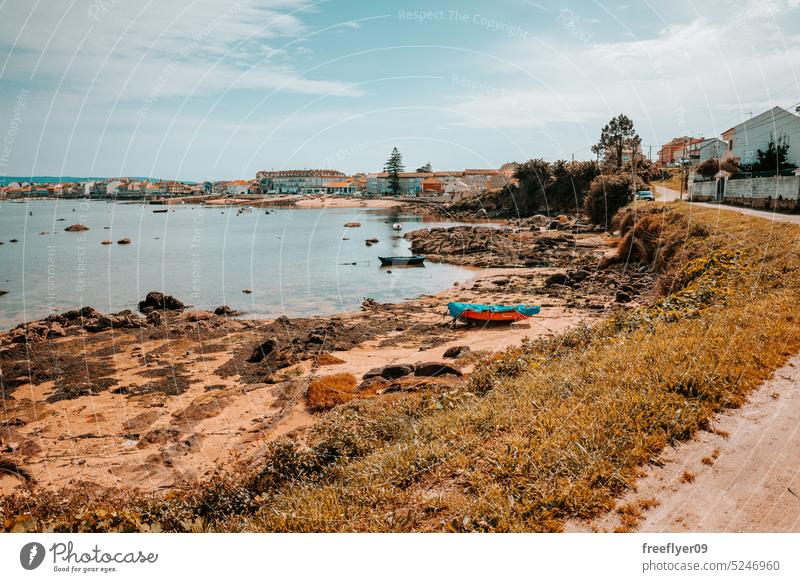 Shore with a beach and fishing boats coast dock copy space landscape galicia tranquil spain nobody shore water vacation travel sand wave sea summer ocean