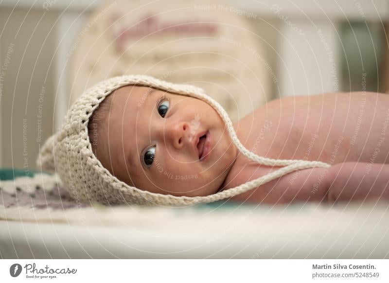 Baby with two months of life in his crib with a wool cap allergy asian baby beautiful beauty body boy breathable caucasian childhood dermatitis dermatology
