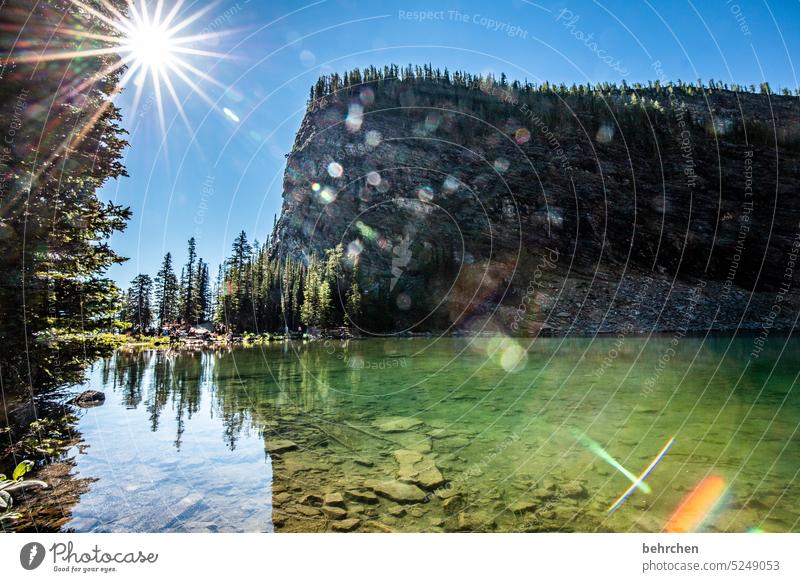 fairytale world Impressive glacial lake Rock stones Back-light solar star Sunlight Alberta Adventure Freedom Lake Landscape Mountain Canada Exterior shot Nature