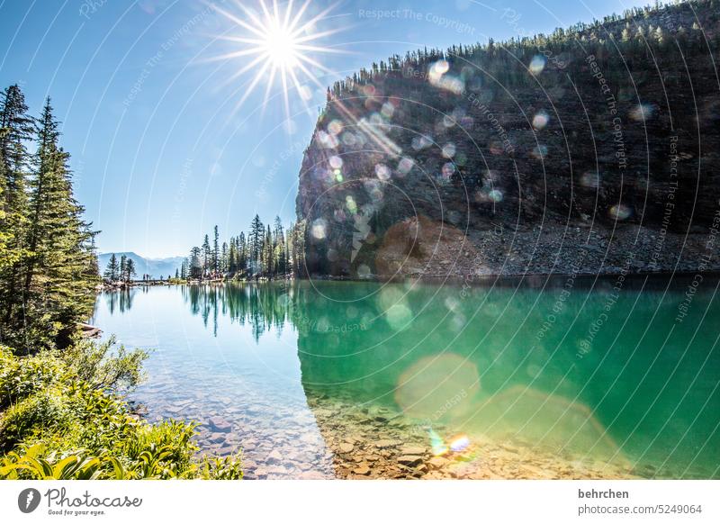 magical world Impressive glacial lake Rock stones Back-light Adventure Freedom Alberta Sun Sunlight solar star Lake Landscape Mountain Canada Exterior shot