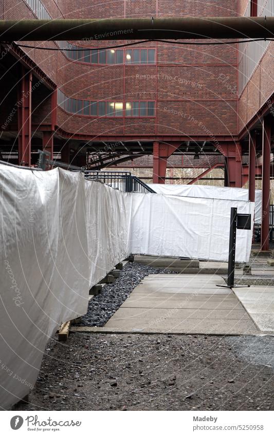Construction fence artfully covered with white cloths at shaft XII of the Zollverein colliery in Essen in the Ruhr area in North Rhine-Westphalia in Germany