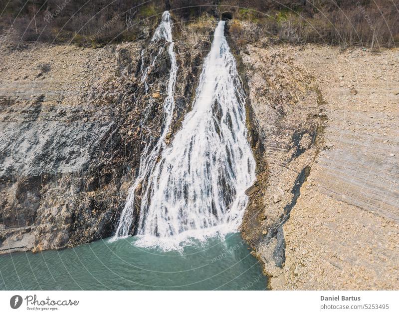 Panoramic drone shot of a waterfall flowing into Lac Chambon in French Alps active alpes alps alps mountains alps summer background barrage beautiful chambon