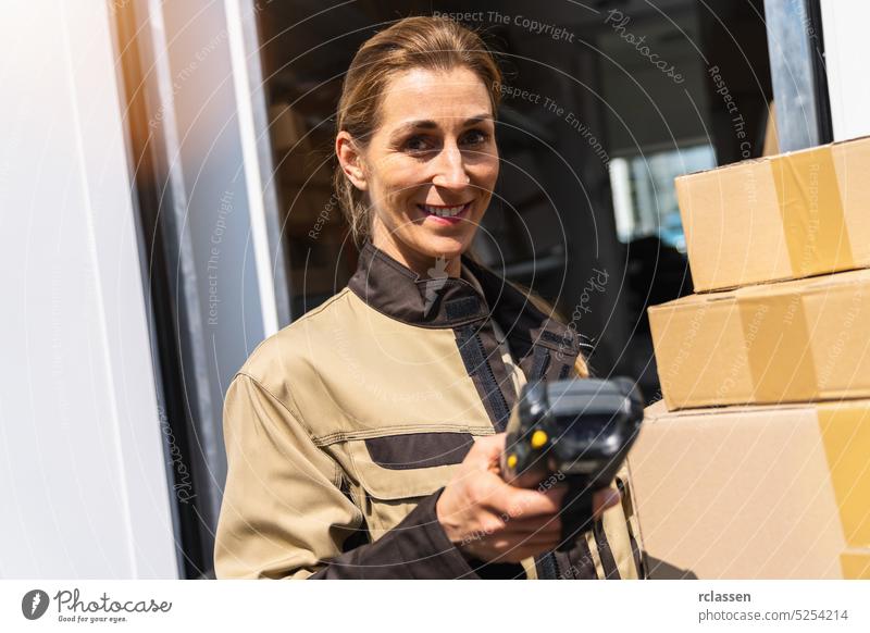 female delivery agent holding barcode scanner outside her van with parcels smiling happy service delivery man order mail laser scanner computer touchscreen