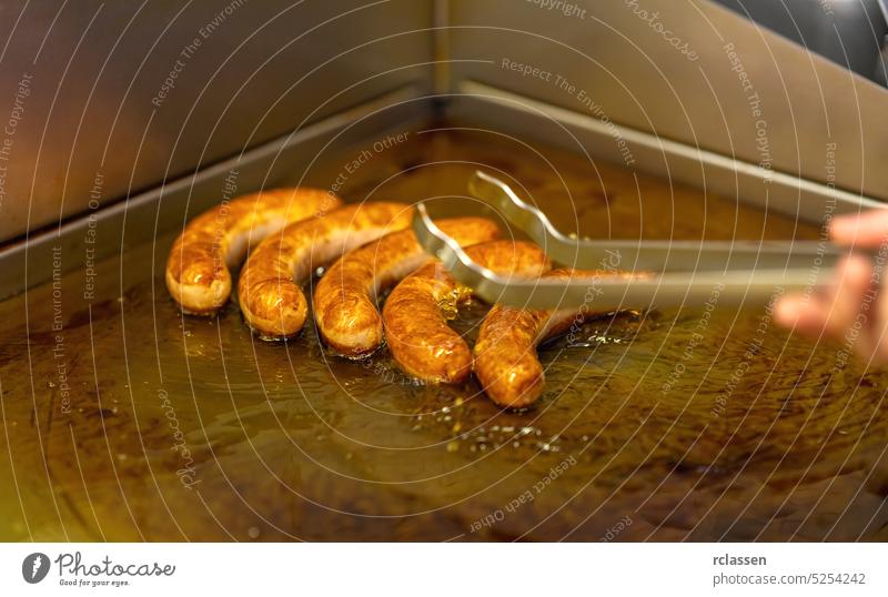 man fryes currywurst Sausage on a Frying plate restaurant berlin junk food hotdog sausage eating bratwurst calories city diet fat fried germany lunch meal meat