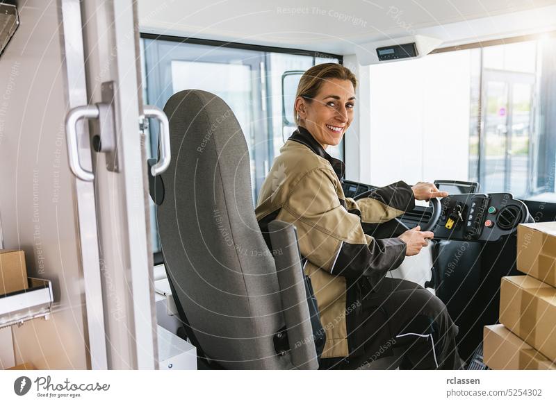 Delivery woman driving van with packages on the front seat. Happy female courier in truck. Portrait of confident express courier driving his delivery van. Courier Delivery concept image