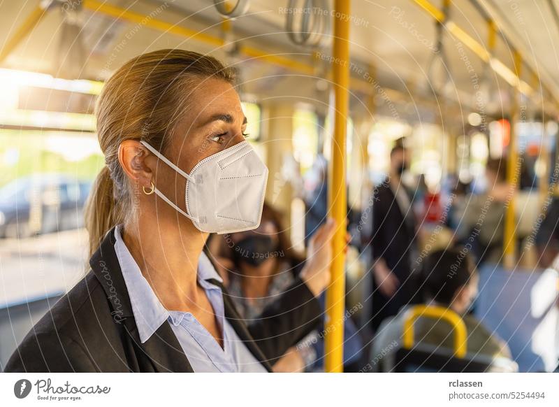 woman with medical FFP3 mask in the subway ffp2 mask handle train city wearing coronavirus people rush hour standing healthy lifestyle person safety urban