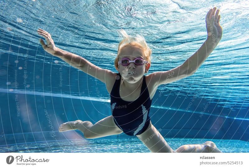 child diving in masks underwater in swimming pool. water sport outdoor adventure, swimming lessons on summer holidays. kid childhood kids hotel snorkel dive