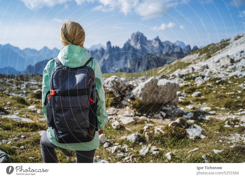 Woman hiker with backpack against Cadini di Misurina mountain group range of Italian Alps, Dolomites, Italy, Europe view dolomites women cadini mountains
