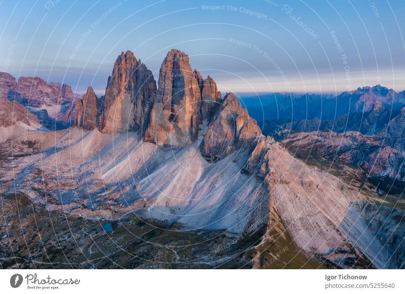 Aerial view of Tre Cime peaks at pink sunset light, Dolomites Alps. National Nature Park, Italy aerial dolomites italy cime lavaredo tre sky park outdoor nature