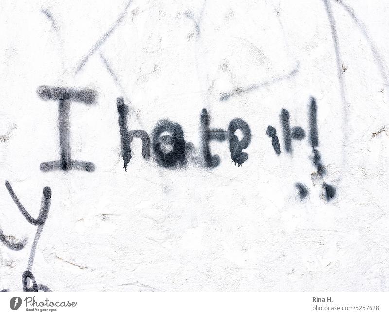 *I hate it * saying with black paint on a white wall Wall slogan Hatred frustrated writing depression Letters (alphabet) black-and-white