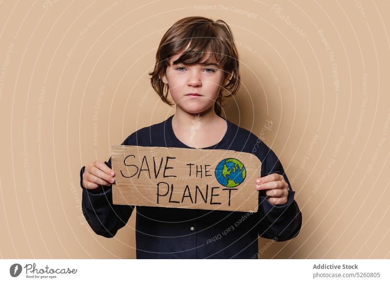 Girl with Save the Planet poster girl environment activist handmade carton save planet earth hand drawn child protest demonstrate ecology inscription placard