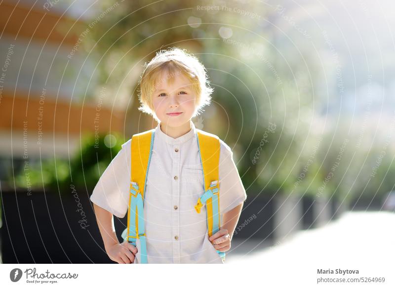 https://www.photocase.com/photos/5264969-little-schoolboy-joyfully-goes-to-school-after-holiday-child-in-a-yard-of-schoolhouse-quality-education-for-children-kids-back-to-school-photocase-stock-photo-large.jpeg