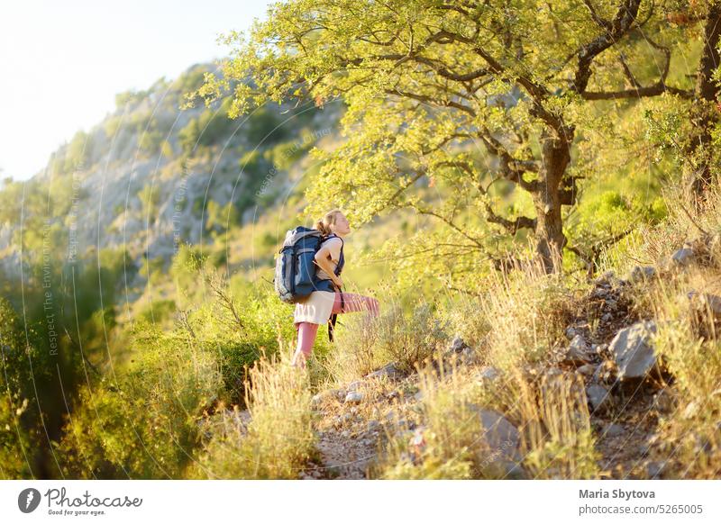 Young woman hiking on mountains in Europe. Concepts of adventure, extreme survival, orienteering. Backpacking hike. Tourists camp. women young europe