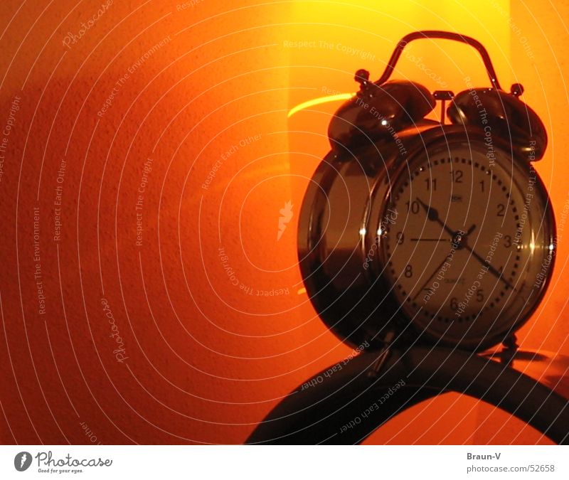 Alarm clock on Height Clock Yellow Light Reflection Wall (building) Orange Silver Clock hand Object photography Isolated Image Bright background Copy Space left