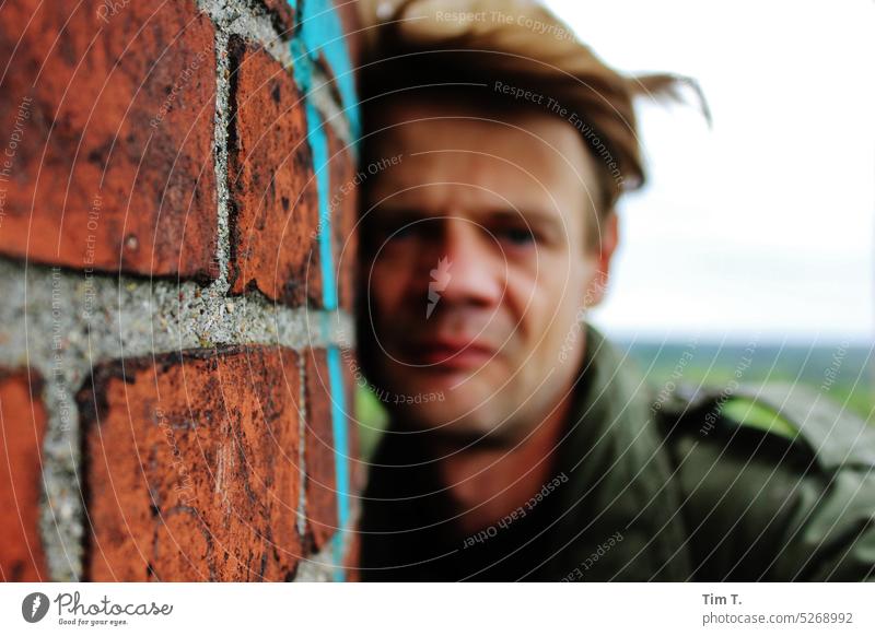 Face of a man on an old wall Man Wall (barrier) Brandenburg Colour photo Exterior shot Day Wall (building) Building