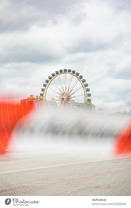 Ferris wheel with fluttering barrier tape in front of it Ferris wheel ride Spring celebration Munich Judder cordon Sky Theresienwiese Leisure and hobbies Joy