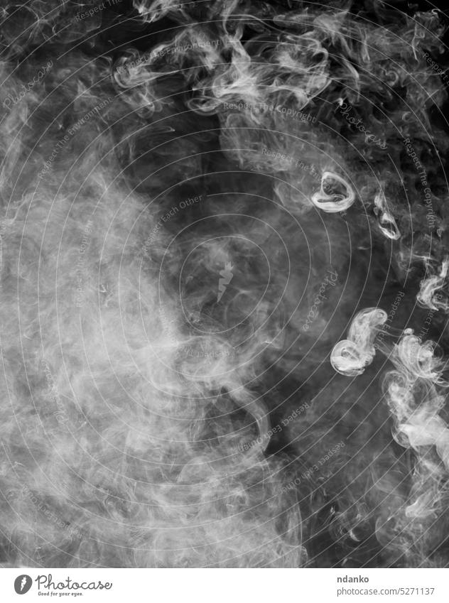 Puffs of smoke on a black background wave white steam swirl abstract fog puff cloud mist flowing fire gas transparent air gray smoky nobody