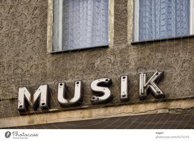 MUSIC remains | Old, defective neon sign on unrenovated house facade. Music Neon sign Letters (alphabet) Typography Retro dilapidated Broken broken vintage